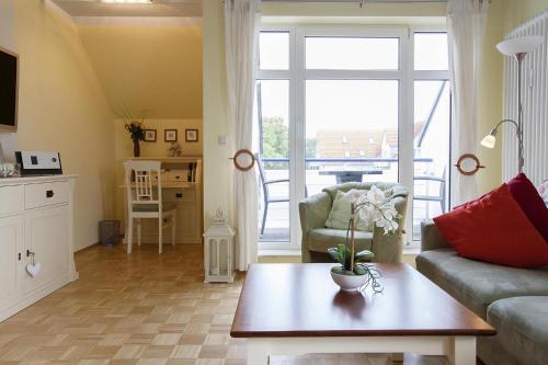 a living room with a couch and a table at Apartment in Boltenhagen near the sea in Boltenhagen