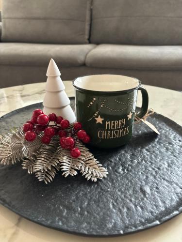 a christmas tree and a cup of coffee on a table at Planai Ski Slope Appartements in Schladming