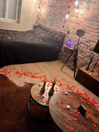 a room with a bed and a table with flowers on it at Just'un Instant in Landrecies