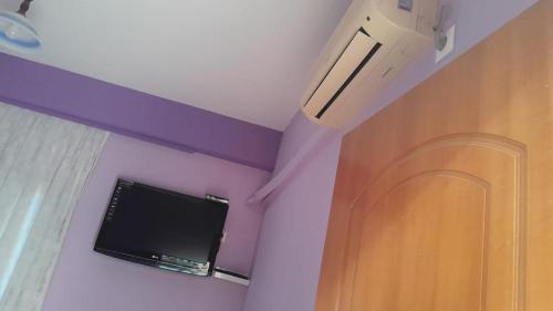 a flat screen tv on the ceiling of a room at Vila Lida in Sarandë