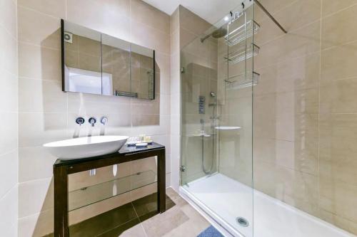 a bathroom with a sink and a shower at 2 Bed Flat South Kensington in London