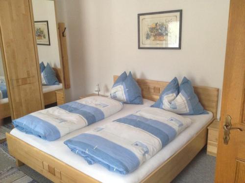 a bedroom with two beds with blue pillows at Haus Barbara Breuer in Neukirchen am Großvenediger