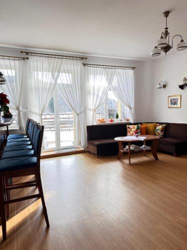 a living room with a couch and a table at Boży Dar in Krynica Zdrój