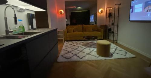 a kitchen and a living room with a couch at Stockholm City in Stockholm