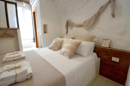 a white bed with white pillows in a bedroom at Casa Matteotti by Wonderful Italy in Conversano
