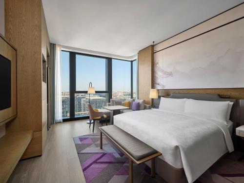 a hotel room with a bed and a view at JW Marriott Hotel Xi'an Southwest in Xi'an