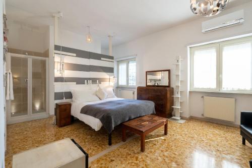 a bedroom with a bed with a striped wall at Locanda Delle Corse in Rome