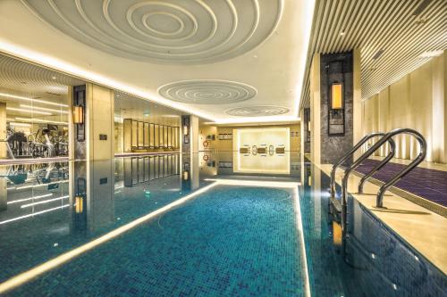 a large swimming pool in a building with a ceiling at Chengdu Marriott Hotel Financial Centre in Chengdu