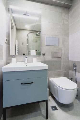 a bathroom with a white sink and a toilet at 8th Hill Apartments in Plovdiv
