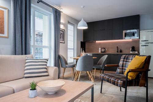 a living room with a couch and a table at 8th Hill Apartments in Plovdiv