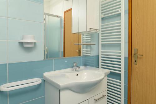 a bathroom with a white sink and a mirror at Villa Rojnići 1 by IstriaLux in Orihi