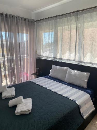 a bedroom with a bed with two towels on it at Luxury Apartment 2 in Alexandroupoli