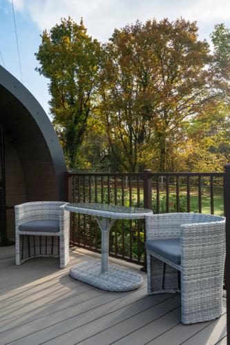 a patio with a table and chairs on a deck at Little Quarry Glamping Bed and Breakfast in Tonbridge