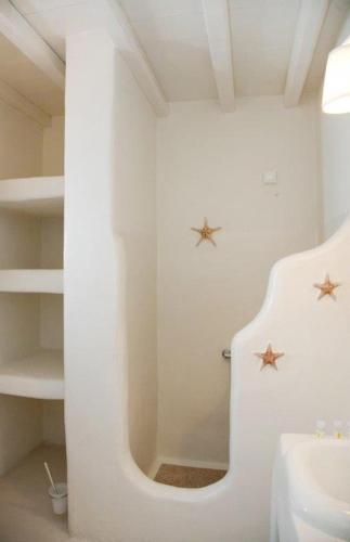 a white bathroom with two stars on the wall at Altana Boutique Hotel in Tinos Town