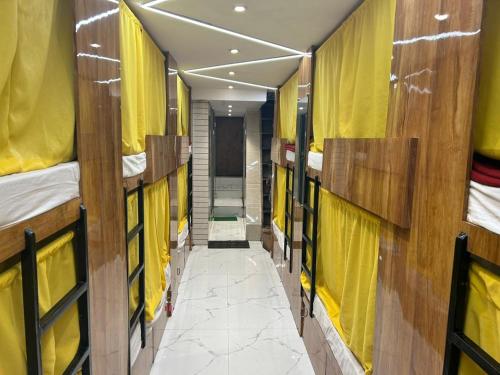a corridor of a train with many bunk beds at Sai Sharan Dormitory-Near Dadar Railway Station in Mumbai