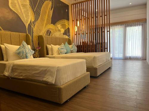 2 letti in camera d'albergo di MAHAMAYA Gili Meno a Gili Meno
