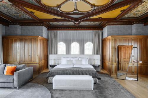 a bedroom with a large bed and a couch at Château d'Ouchy in Lausanne