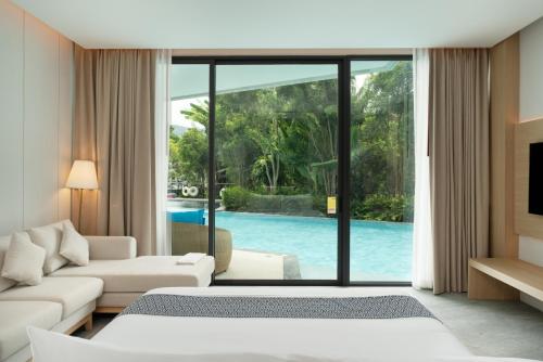 a hotel room with a view of a pool at Timberton Resort Khaoyai in Ban Tha Maprang