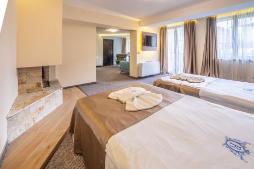 En eller flere senge i et værelse på Wellness Hotel Bulgaria