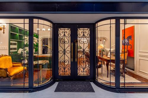 a room with glass doors and a dining room at Golden Sun Apartment & Hotel in Ho Chi Minh City