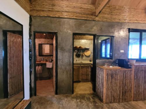 a kitchen with wooden walls and a wooden ceiling at Tarzan's House in General Luna