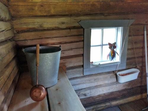 a room with a window in a log cabin at Tiny House in Nattavaara by in Nattavaara