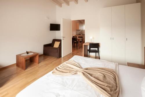 a bedroom with a bed and a living room at Residence Panorama in Brunico