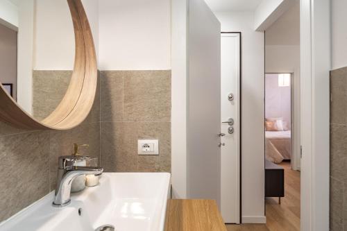 a bathroom with a sink and a mirror at 45Royal stylish house Milan city center in Milan