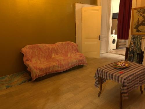- un salon avec une chaise et une table dans l'établissement Aghmashenebeli Apartment, à Tbilissi