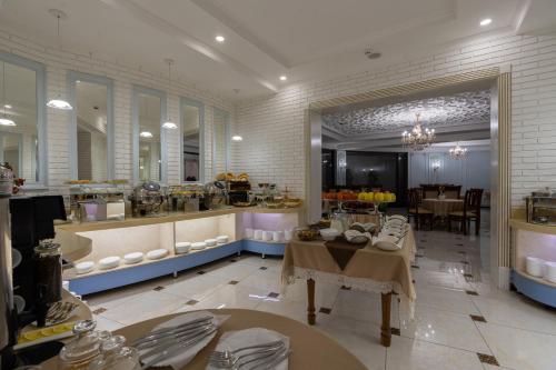 a large kitchen with a table and a dining room at Shoxjahon Hotel - 600 Mbps Internet in Tashkent