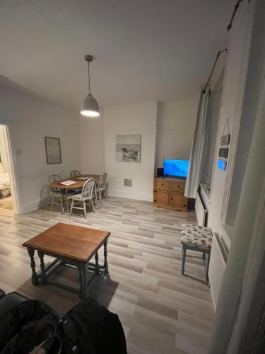 a living room with a table and a dining room at Flat Beside the sea in Southend-on-Sea