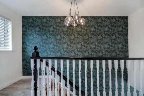 a chandelier hanging over a staircase in a house at The Burrow in Sion Mills