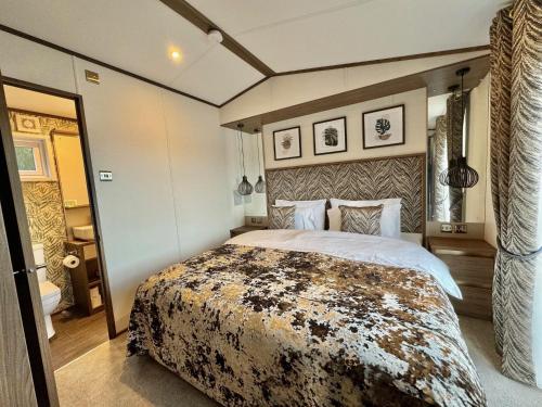 a bedroom with a large bed in a room at Luxury Langham Lodge in Clitheroe