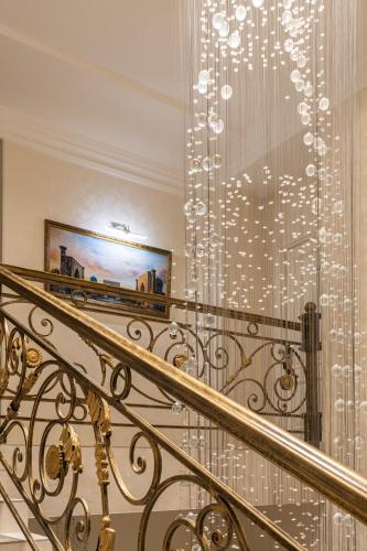 a staircase with a chandelier on the wall at Shoxjahon Hotel - 600 Mbps Internet in Tashkent