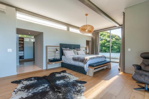 a bedroom with a bed and a large window at Southdown Masterpiece with backup power in Cape Town