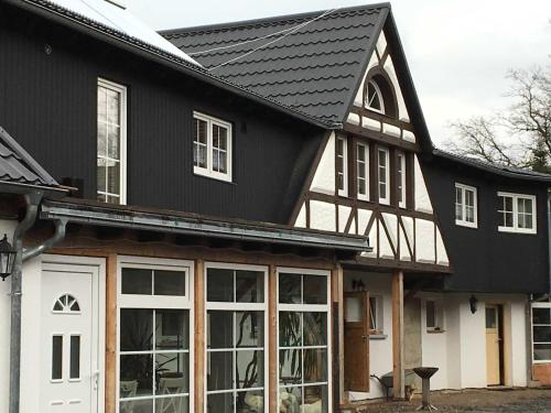 Casa en blanco y negro con ventanas blancas en Ferienhof Homann, en Lindenberg