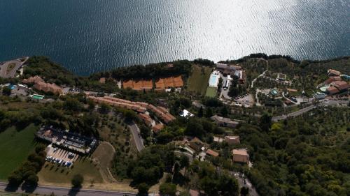 an aerial view of a house on a hill next to the water at CASA NAVLA' AppartamentI "Ulivi"- "Fiori" -"Velieri"-"Luna"-"Nido"-"Taverna" in Tignale