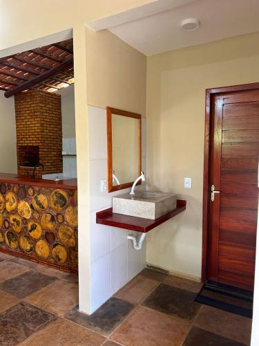 a bathroom with a sink and a mirror on the wall at Imperio dos Bambus Suites in Jijoca de Jericoacoara