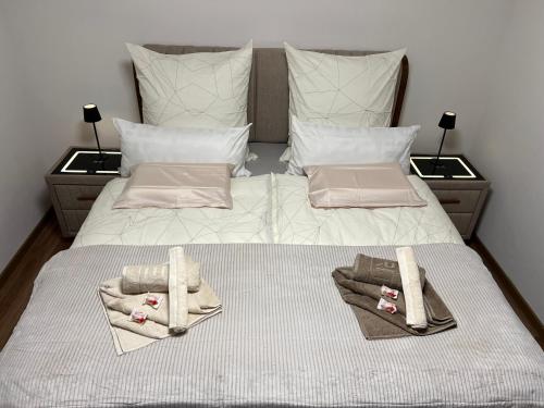 a bedroom with a bed with towels and pillows at Appartement Schwetzingerstadt in Mannheim