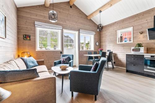 a living room with a couch and chairs and a table at Reine Rorbu, Amaliebua in Reine