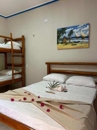 a bedroom with a bed with flowers on it at Imperio dos Bambus Suites in Jijoca de Jericoacoara