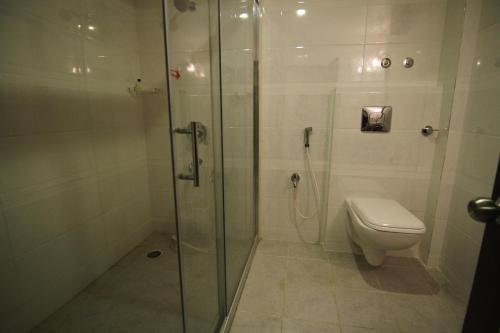 a bathroom with a shower and a toilet at Hotel green apple in Visakhapatnam