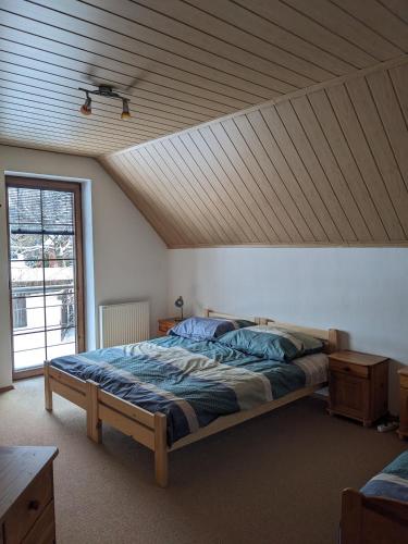 a bedroom with a bed with a wooden ceiling at INFINITA Bodice in Liptovský Mikuláš