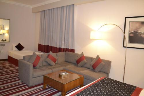 a living room with a couch and a table at Wonder Palace Hotel Qatar in Doha