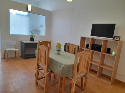 a dining room with a table and chairs and a television at KaVa in Rawson