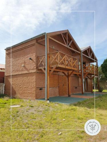 an image of a house with a large building at Jarillas del Mar in Las Grutas