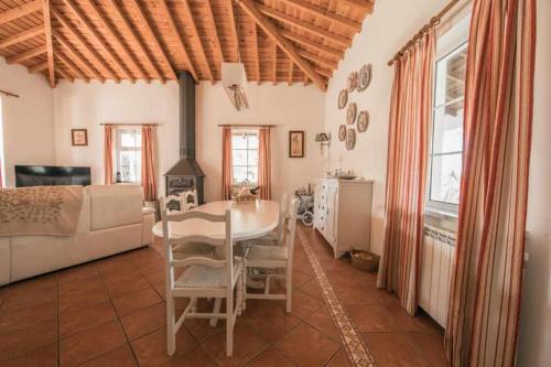 a living room with a table and a couch at Outeiro do Álamo by Portus Alacer in Cabeço de Vide