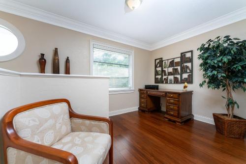 a living room with a chair and a desk at Villa Hibiscus-Waterfront-Punta Gorda FL in Punta Gorda