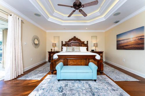 a bedroom with a bed and a ceiling fan at Villa Hibiscus-Waterfront-Punta Gorda FL in Punta Gorda