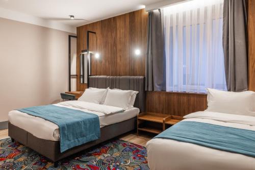 Katil atau katil-katil dalam bilik di Hotel Square by MARGO